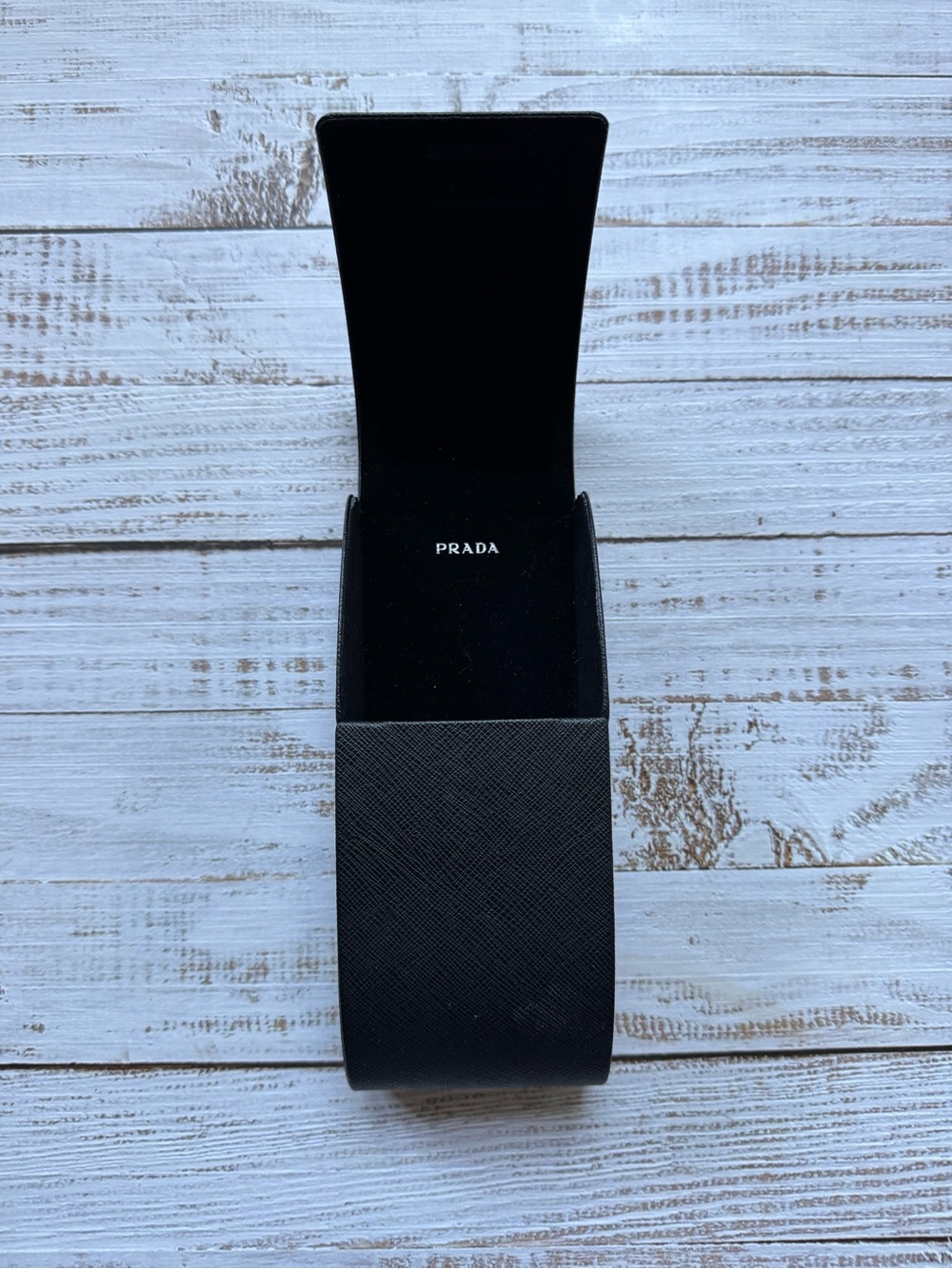 Prada hard sunglasses case featuring a magnetic closure and black velvet lining
